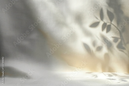 Blur shadow of leaves on white fabric. white cloth background soft wrinkled fabric patrem and surface photo