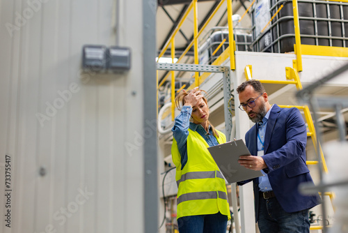 Supervisor, manager scolding employee in modern industry factory. Worker making mistake. Production manger is angry, dissatisfied for worker's poor quality work, safety viaolations. Gender harassment