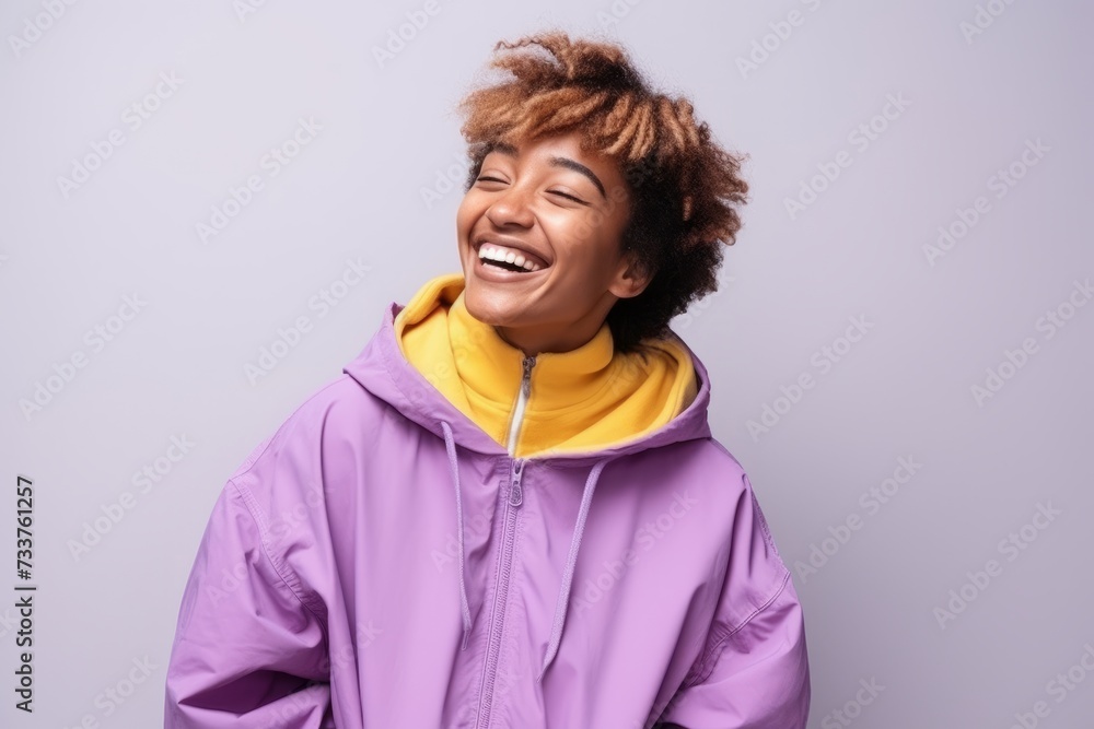 Portrait of a happy african american woman laughing against grey background Portrait of a happy african american woman laughing against grey background