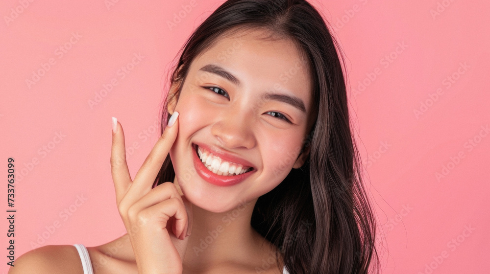 Beautiful young asian woman smile with clean skin on pink background . Beautiful young asian woman smile with clean skin on pink background .
