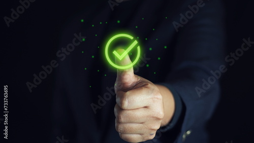 Businessman's hand touching correct glowing sign for document approval and project approval concept with copy space.