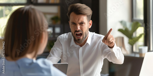 Angry office boss shouting, arguing and threatening his employee. Anger management concept. photo