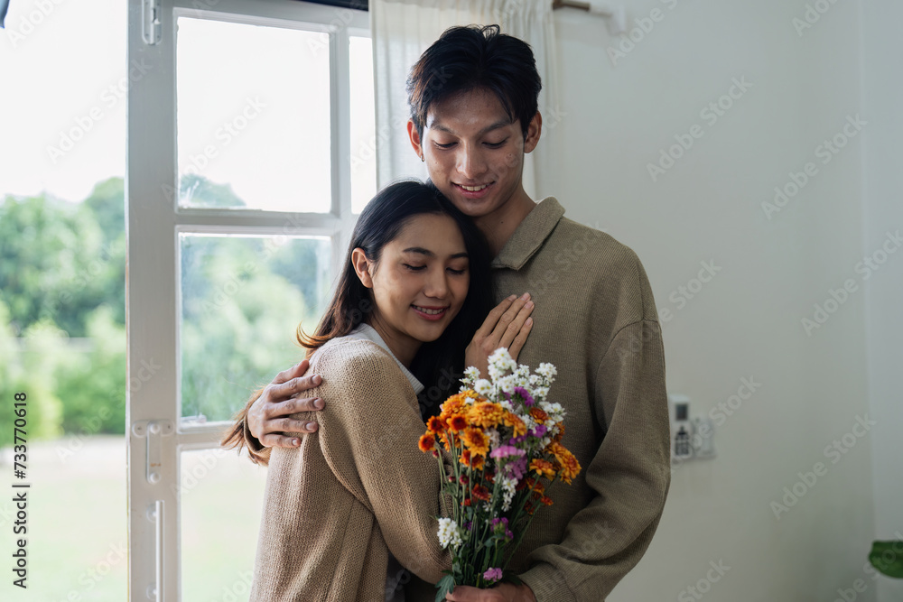 Young couple Hug and giving flower on Valentine's Day. Romantic day together. Valentine's Day concept