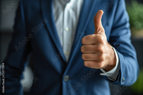 Confident Man in a Suit Giving a Thumbs Up