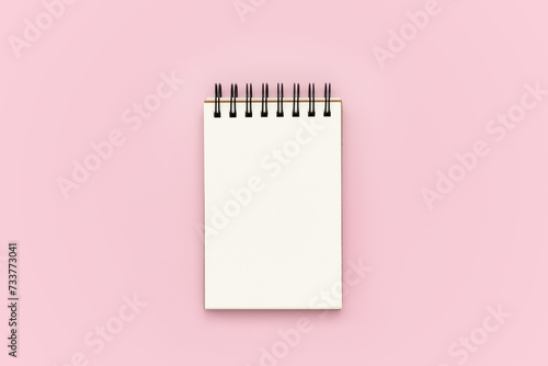 Blank notebook on pink background