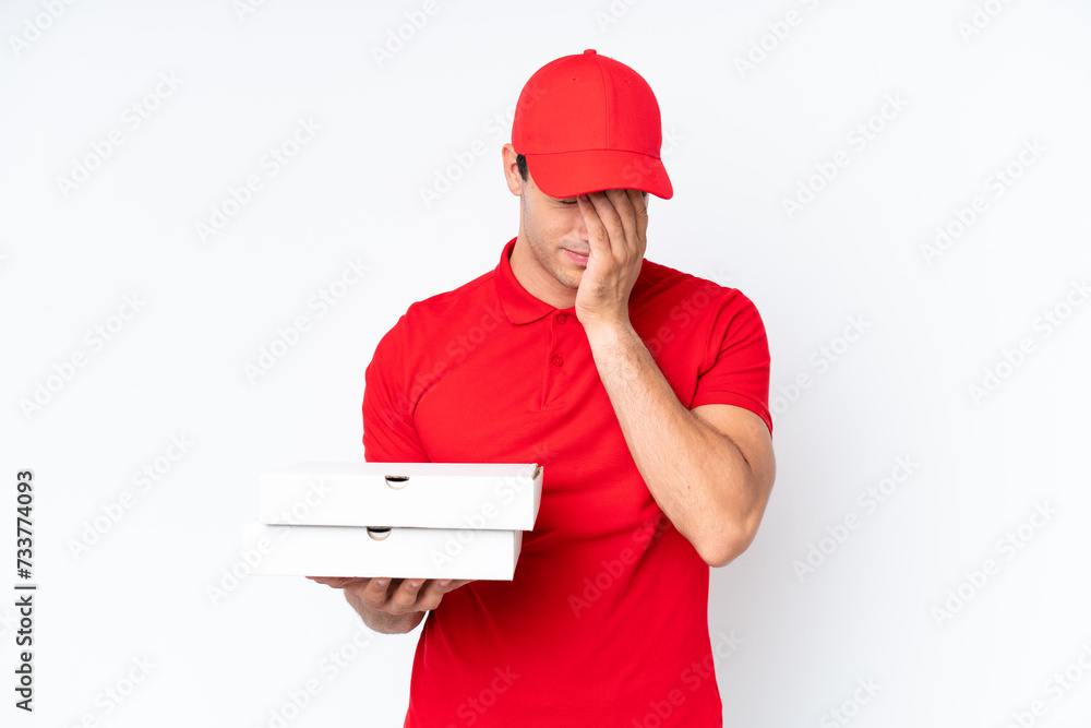 Pizza delivery caucasian man with work uniform picking up pizza boxes isolated on white background with tired and sick expression Pizza delivery caucasian man with work uniform picking up pizza boxes isolated on white background with tired and sick expression