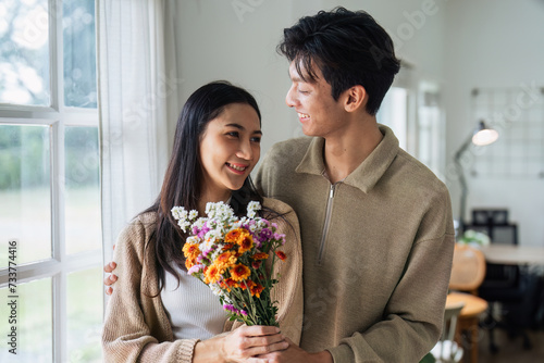 Young couple Hug and giving flower on Valentine's Day. Romantic day together. Valentine's Day concept