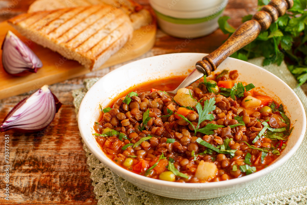 Homemade brown lentil stew with carrots, onions and tomatos. Comfort winter food. Homemade brown lentil stew with carrots, onions and tomatos. Comfort winter food.