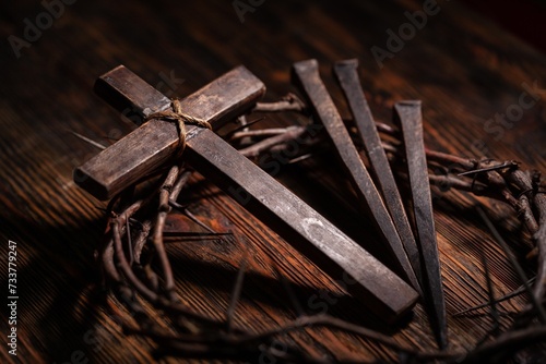 Christian cross with crown thorns on dark background.