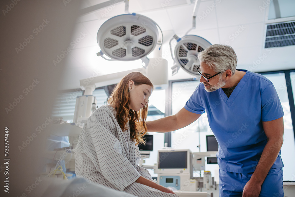 Obraz premium Supportive doctor talking with worried teenage patient. Compassionate physician supporting stressed girl, delivering bed news.