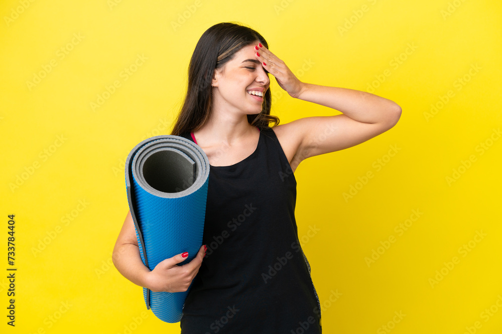 sport Italian woman going to yoga classes isolated on yellow background smiling a lot sport Italian woman going to yoga classes isolated on yellow background smiling a lot