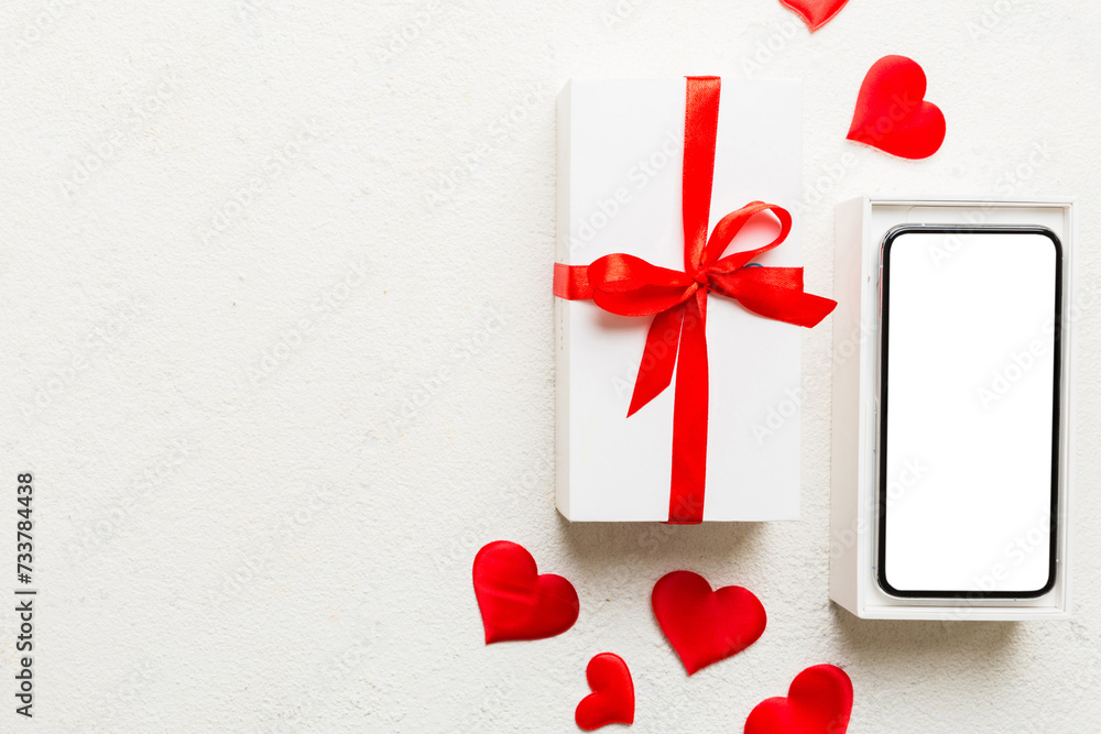 Opened gift box with ribbon and phone on color background, top view. Blank open box packaging mockup , Template for your design - branding mockup Opened gift box with ribbon and phone on color background, top view. Blank open box packaging mockup , Template for your design - branding mockup