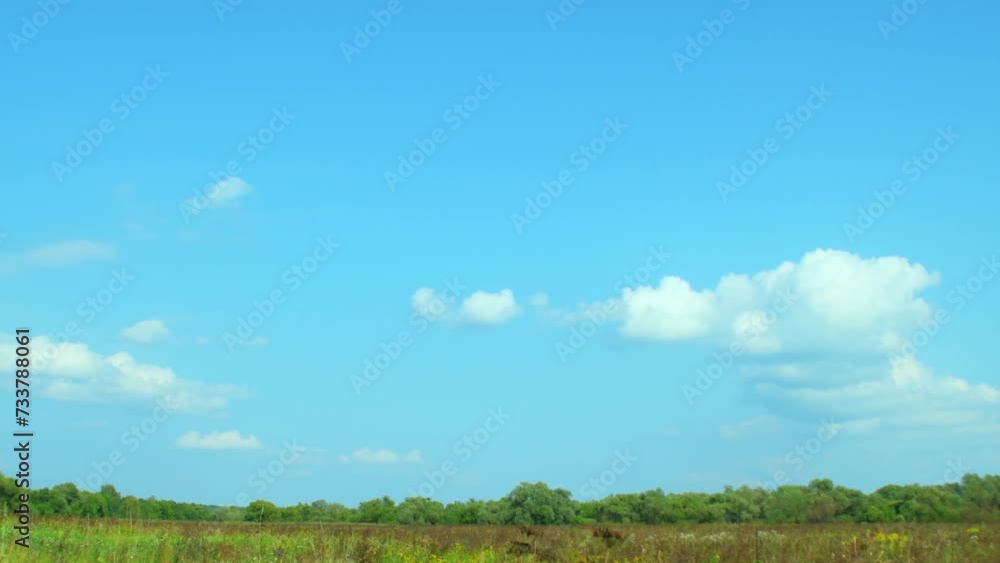 Summer background with blue sky and small clouds over a dry field. Drought in a fertile area. Summer background with blue sky and small clouds over a dry field. Drought in a fertile area.
