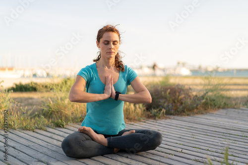 Young woman at outdoors doing yoga © luismolinero