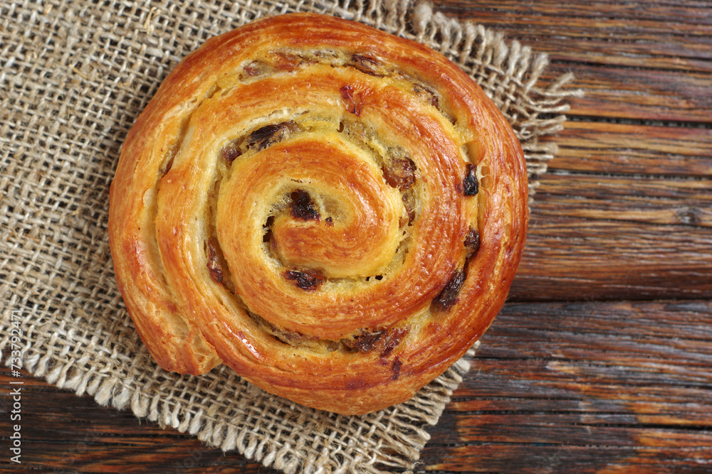 Fototapeta premium Puff pastry bun with raisins