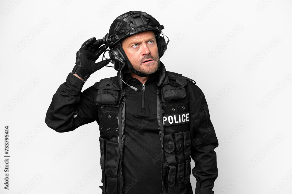 Middle age SWAT man isolated on white background having doubts and with confuse face expression Middle age SWAT man isolated on white background having doubts and with confuse face expression