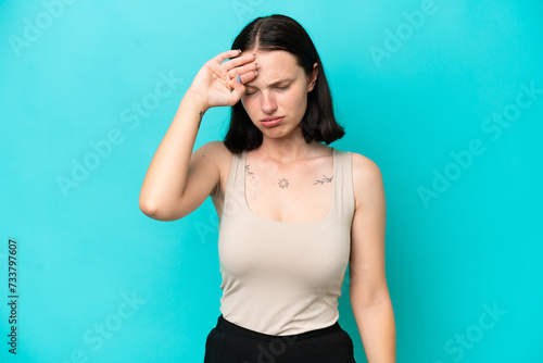 Young caucasian woman isolated on blue background with tired and sick expression
