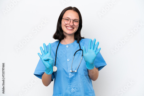 Young nurse caucasian woman isolated on white background counting nine with fingers