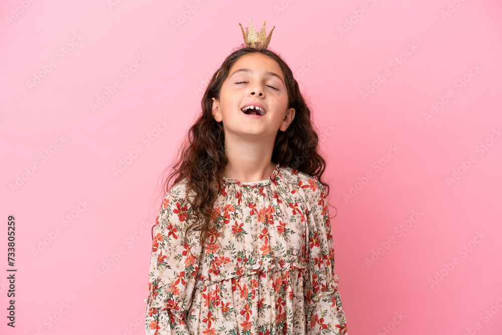 Little caucasian princess with crown isolated on pink background laughing Little caucasian princess with crown isolated on pink background laughing