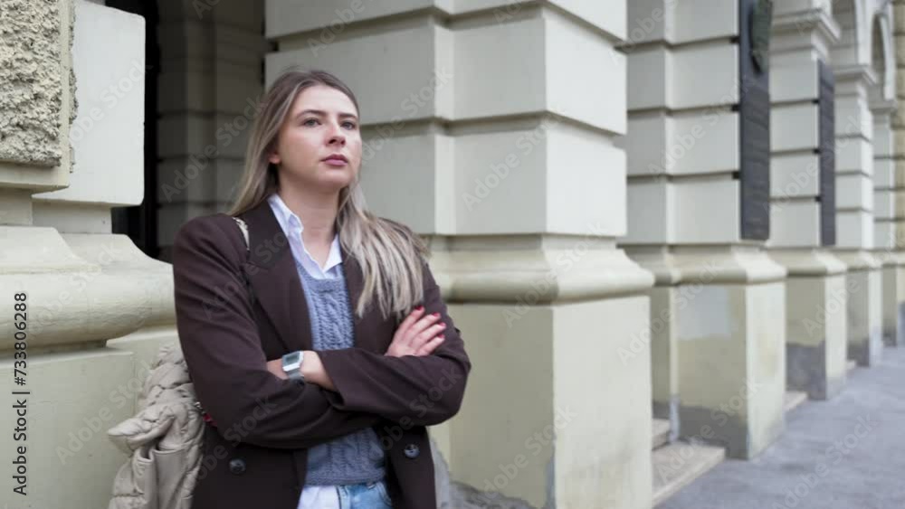 Young nervous business woman standing on the street waiting her friend or boyfriend who is late to date. Hungry female wait for companion or colleague for meeting lunch to restaurant or cafeteria. Young nervous business woman standing on the street waiting her friend or boyfriend who is late to date. Hungry female wait for companion or colleague for meeting lunch to restaurant or cafeteria.