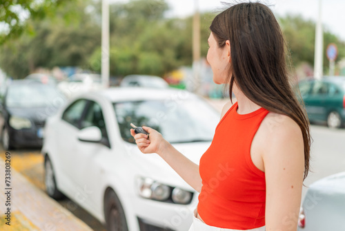 Young pretty woman at outdoors holding car keys © luismolinero