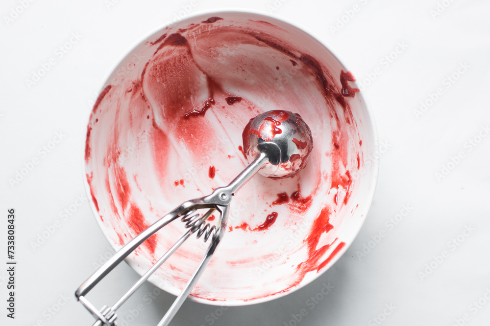 Red velvet cake batter in a bowl that has been scraped clean, Leftover cake batter in a white mixing bowl Red velvet cake batter in a bowl that has been scraped clean, Leftover cake batter in a white mixing bowl