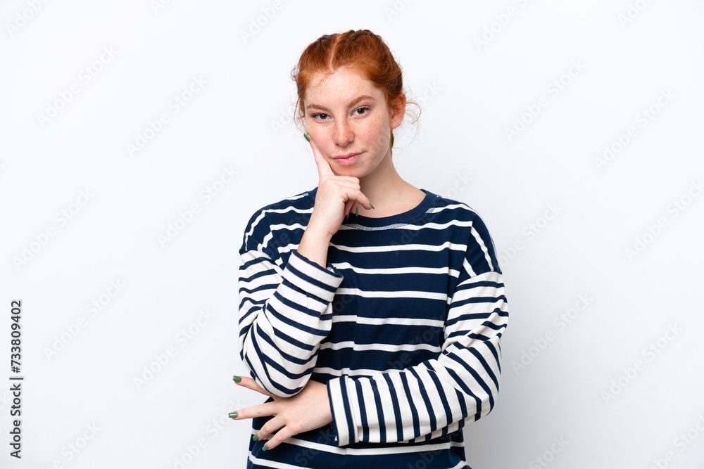 Young reddish woman isolated on white background and thinking Young reddish woman isolated on white background and thinking