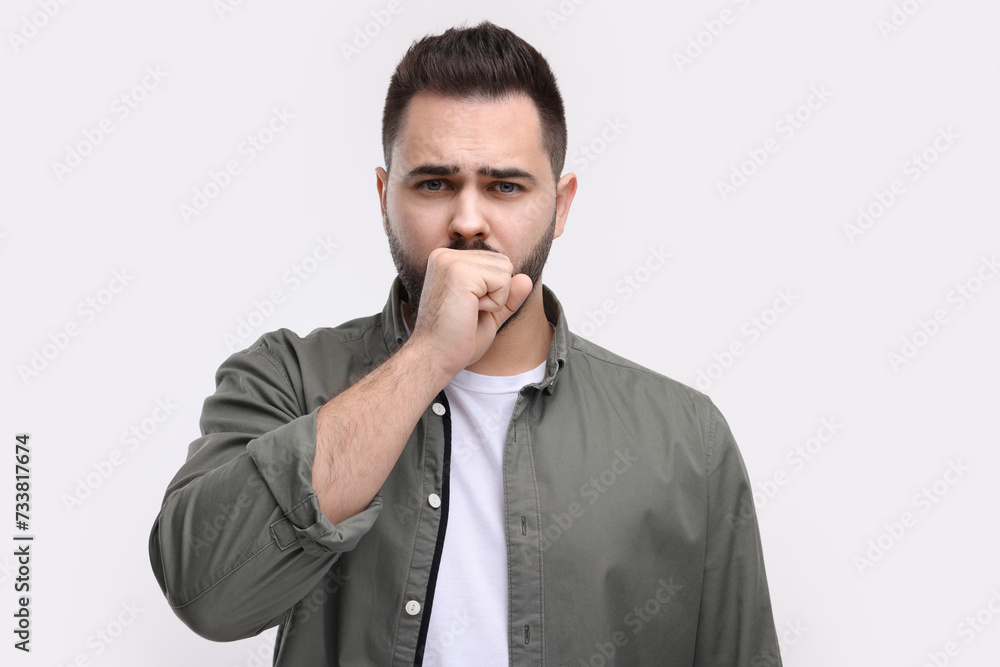 Sick man coughing on white background. Cold symptoms Sick man coughing on white background. Cold symptoms