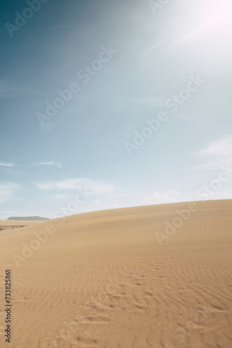 Sand desert dunes landscape with blue sky in background - concept of climate change and arid future on the planet earth - enviroment and outdoor nature scenic place