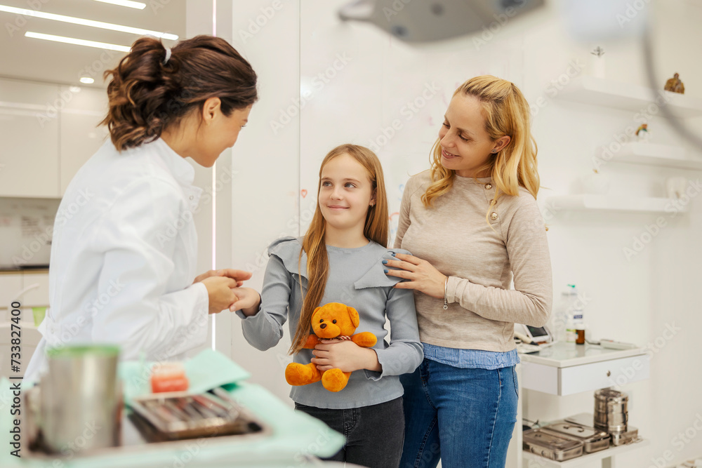 A young girl with her mom in visit to a dentist. A young girl with her mom in visit to a dentist.