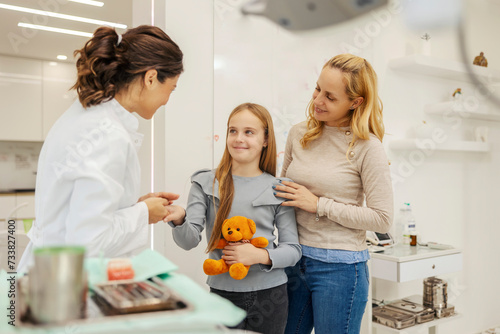 A young girl with her mom in visit to a dentist.
