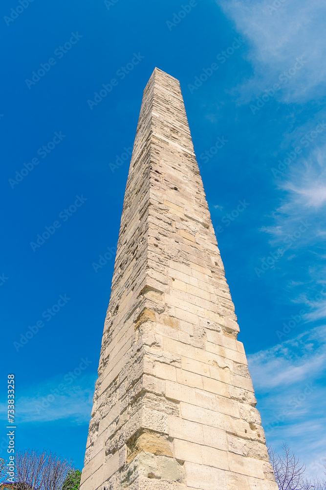 Obelisk of Constantine in Istanbul. An ancient obelisk against the blue sky.