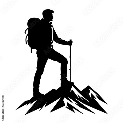 silhouette of a man standing  on mount with backpack and hiking stick in his hand.