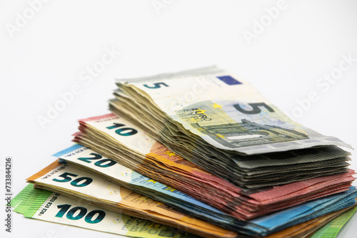 Pile of euro banknotes of 100, 50, 20, 10 and 5 euros. White background