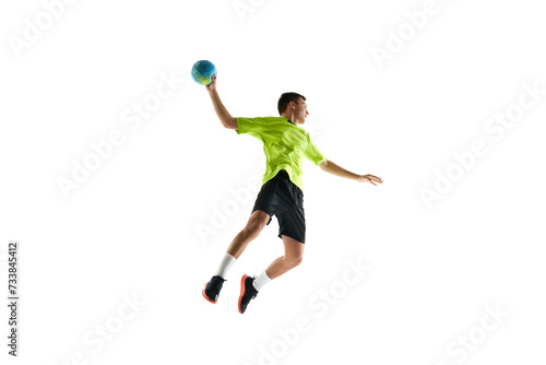 Concentrated and motivated young man, handball player in motion during game, training, playing against white studio background. Concept of professional sport, tournament, competition