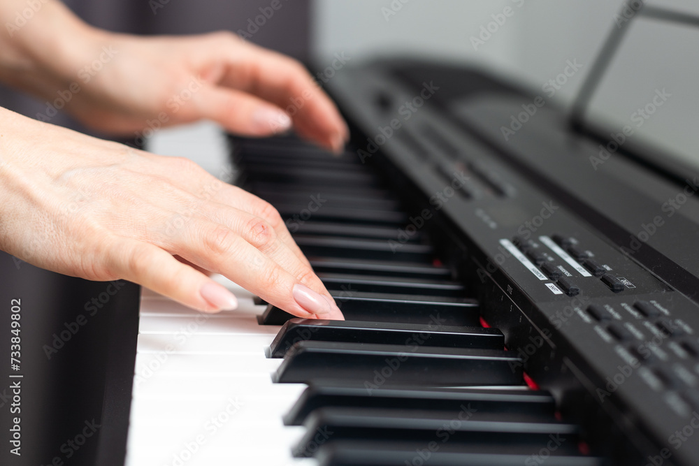 Fototapeta premium keyboard and hands playing the piano