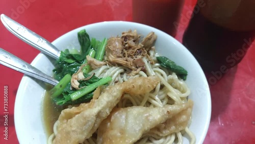 Pangsip noodles on the table and a pair of spoons and forks ready to eat photo