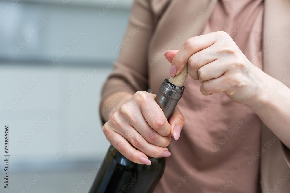 Fototapeta premium The bottle is in female hands.