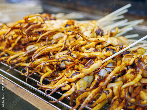 Grilled squid tentacles on skewers, street food