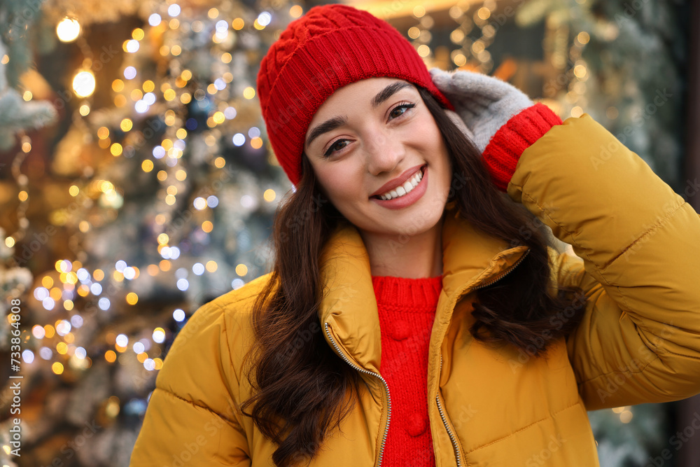 Portrait of smiling woman on blurred background. Winter time Portrait of smiling woman on blurred background. Winter time