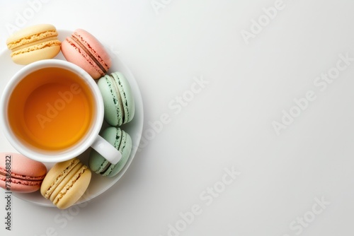 Wallpaper Mural High angle view of a tea cup with multicolored macaroons on white background. The objects are at the right of the image leaving a useful copy space Torontodigital.ca