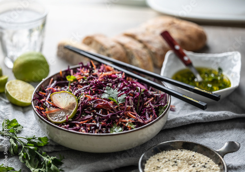 Asian red cabbage and carrot salad seasoned with coriander and sesame photo