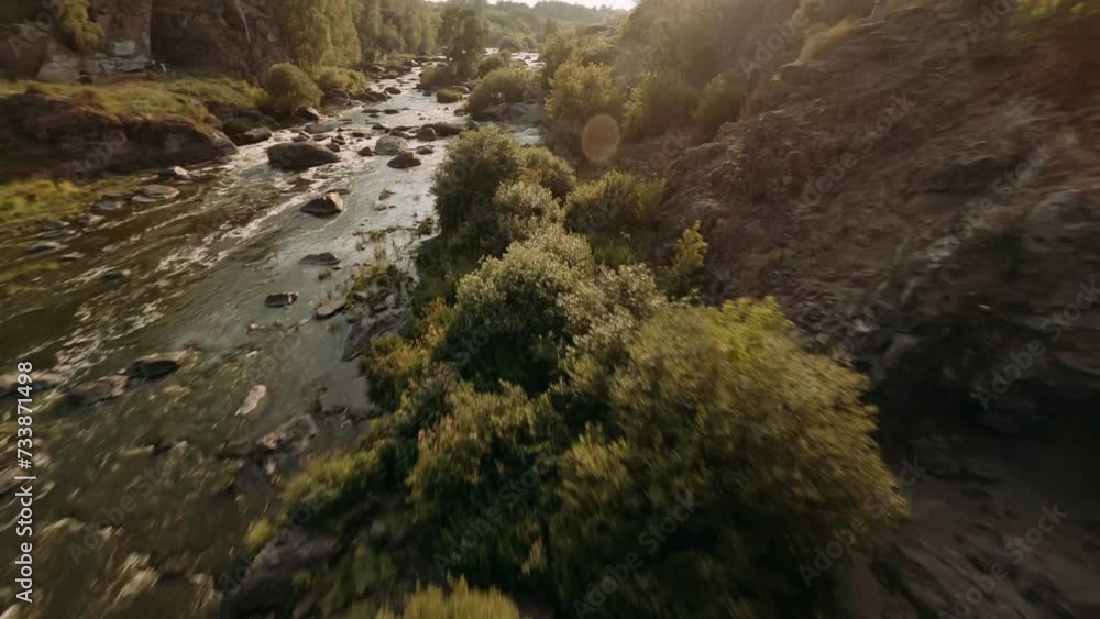 FPV Aerial shot flying at natural landscape river in mountains at sunset. FPV Dynamic drone shot. FPV Aerial shot flying at natural landscape river in mountains at sunset. FPV Dynamic drone shot.