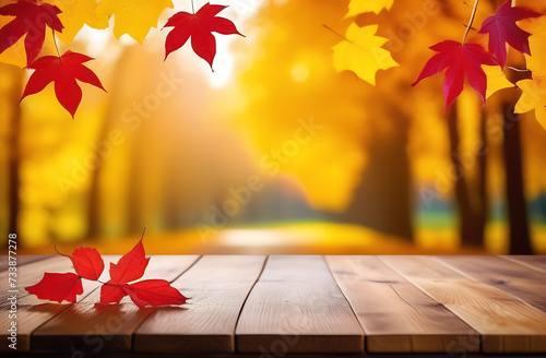 Wooden table and blurred autumn background. Autumn concept with red and yellow leaves