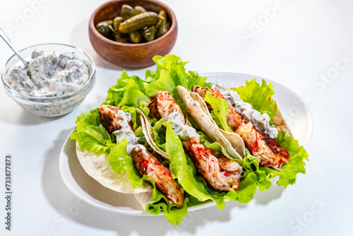 Homemade Mexican tacos with crab sticks and fresh herbs. Healthy food. Traditional Mexican dish.