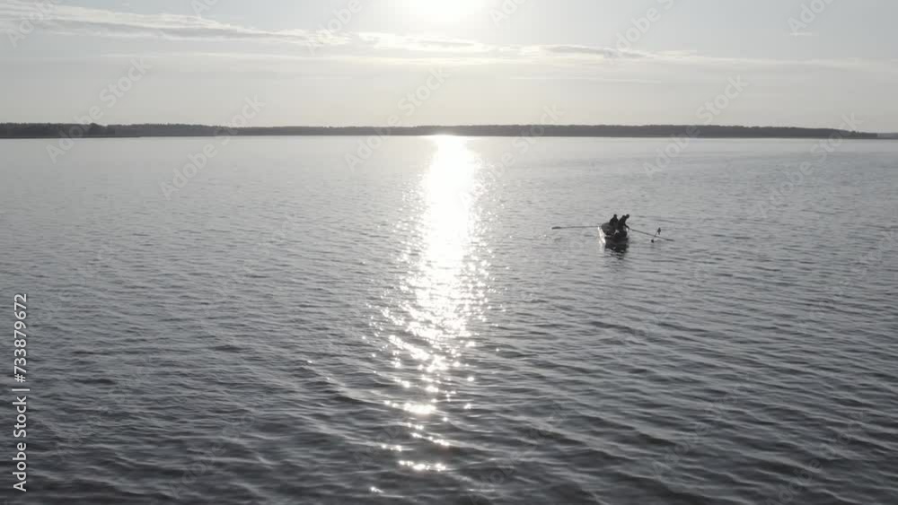 Fishermans boat on lake in sunset Fishermans boat on lake in sunset