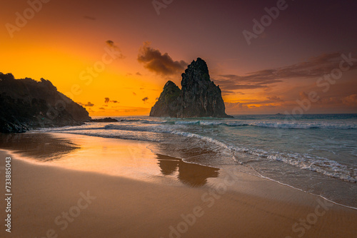 Sunset at Dois Irmãos Rock, Cacimba do Padre beach, Fernando de Noronha Archipelago, Brazil photo