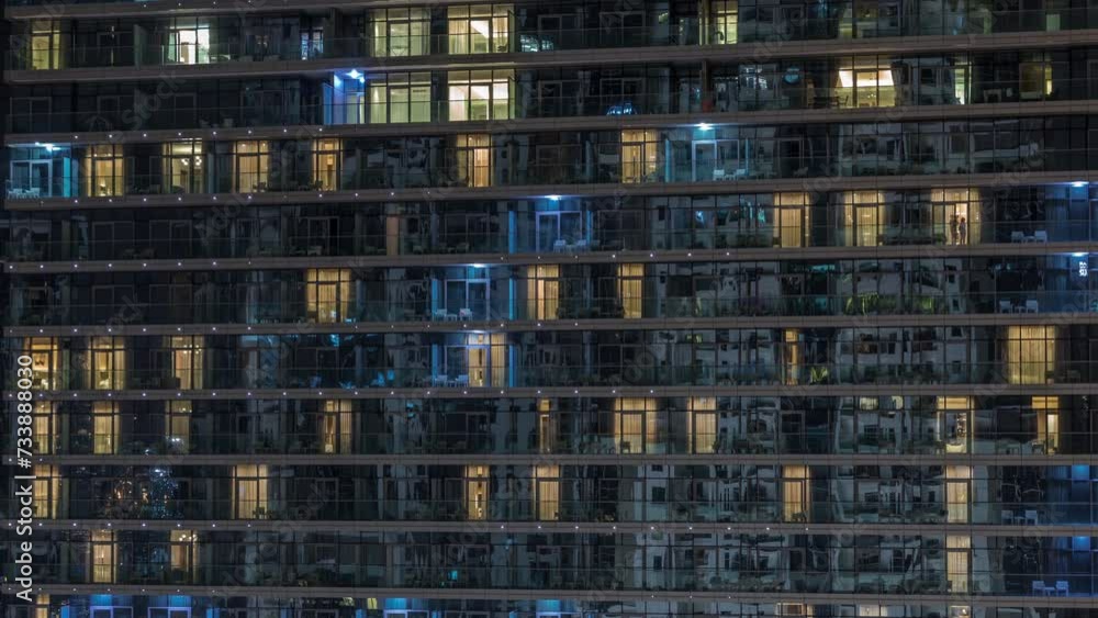 Tall blocks of flats with glowing windows located in residential district of city aerial timelapse. Evening light in rooms in towers and skyscrapers. Balconies with chairs and tables Tall blocks of flats with glowing windows located in residential district of city aerial timelapse. Evening light in rooms in towers and skyscrapers. Balconies with chairs and tables