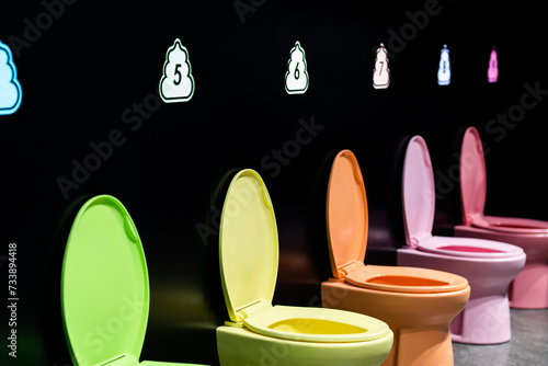 Eye-catching display of modern toilets in a spectrum of vibrant colors, illuminating creative interior design possibilities for home and commercial spaces, showcasing a fusion of comfort and style