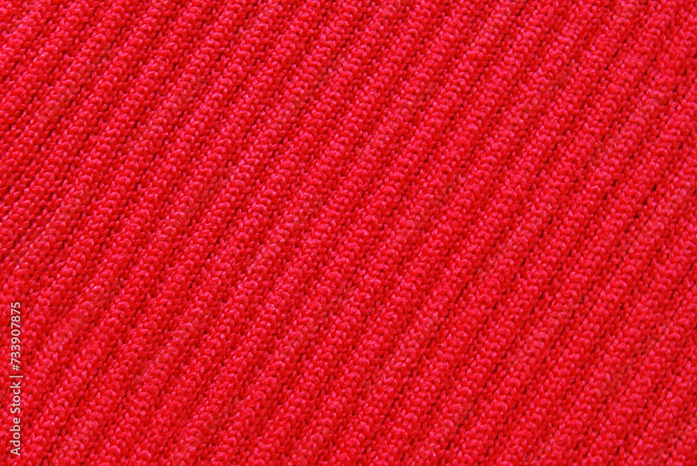 Soft red color ribbed jersey fabric pattern close up as background